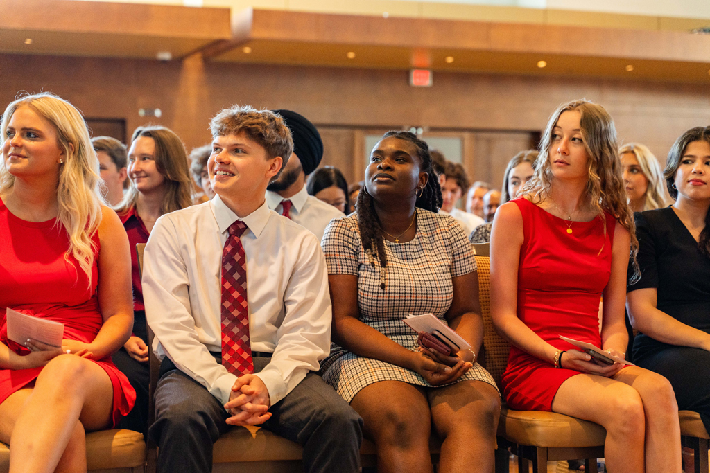 Photo by Paulius Musteikis Students sit in their seats awaiting their white coats