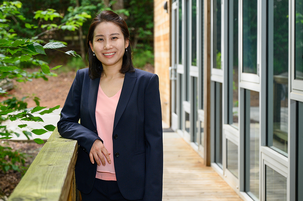 Joohyun Park leans on a railing and smiles.