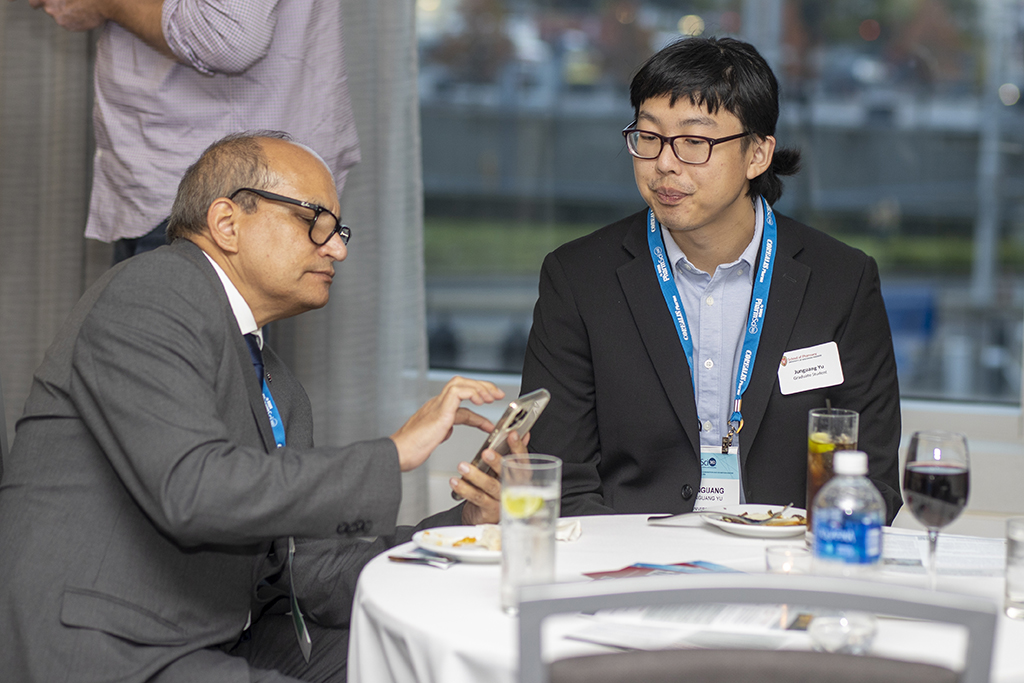 015WU-Boston10-17-22-Osberg An attendee speaking with Junguang Yu.