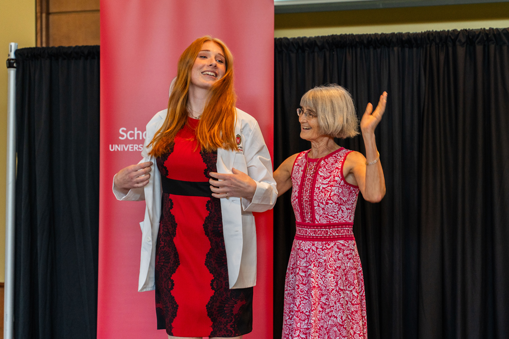 Photo by Paulius Musteikis A student receives her white coat from Mara Kieser