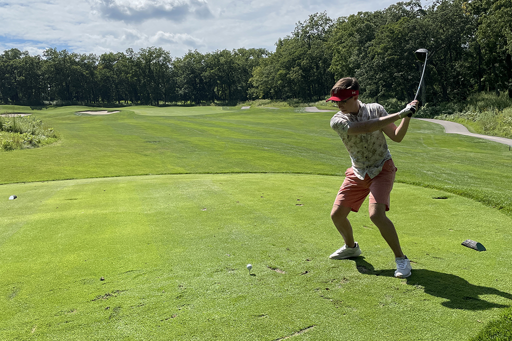 027EF1FC-32E8-42EB-9F74-34FC39723111 An alum taking a swing on the green.