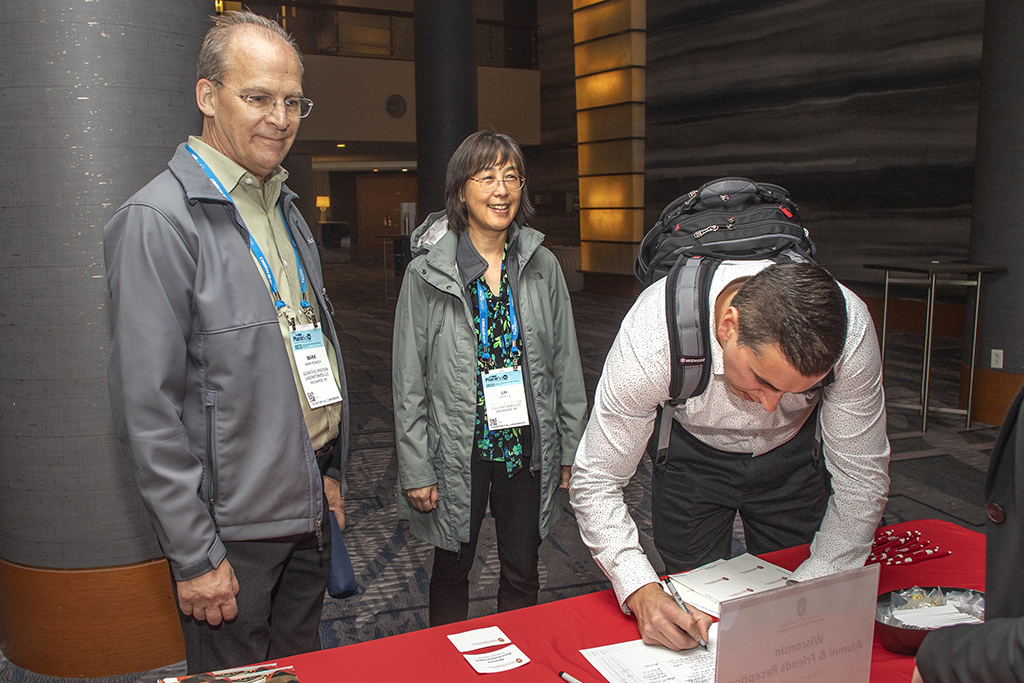 047WU-Boston10-17-22-Osberg Lin Rao, Mark Romich, and other checking in to the event.