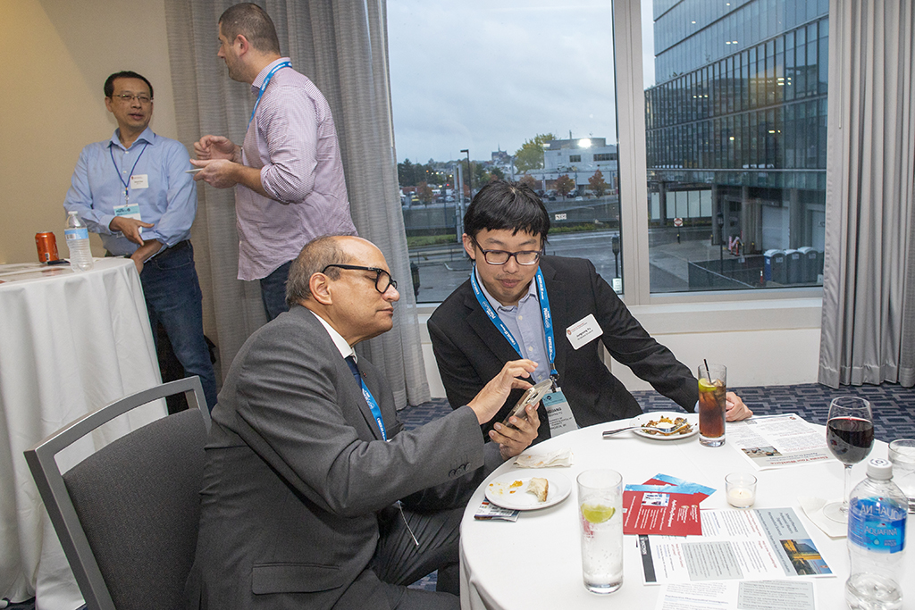 054WU-Boston10-17-22-Osberg An attendee speaking with Junguang Yu