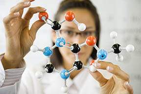 Scientist Holding Molecule