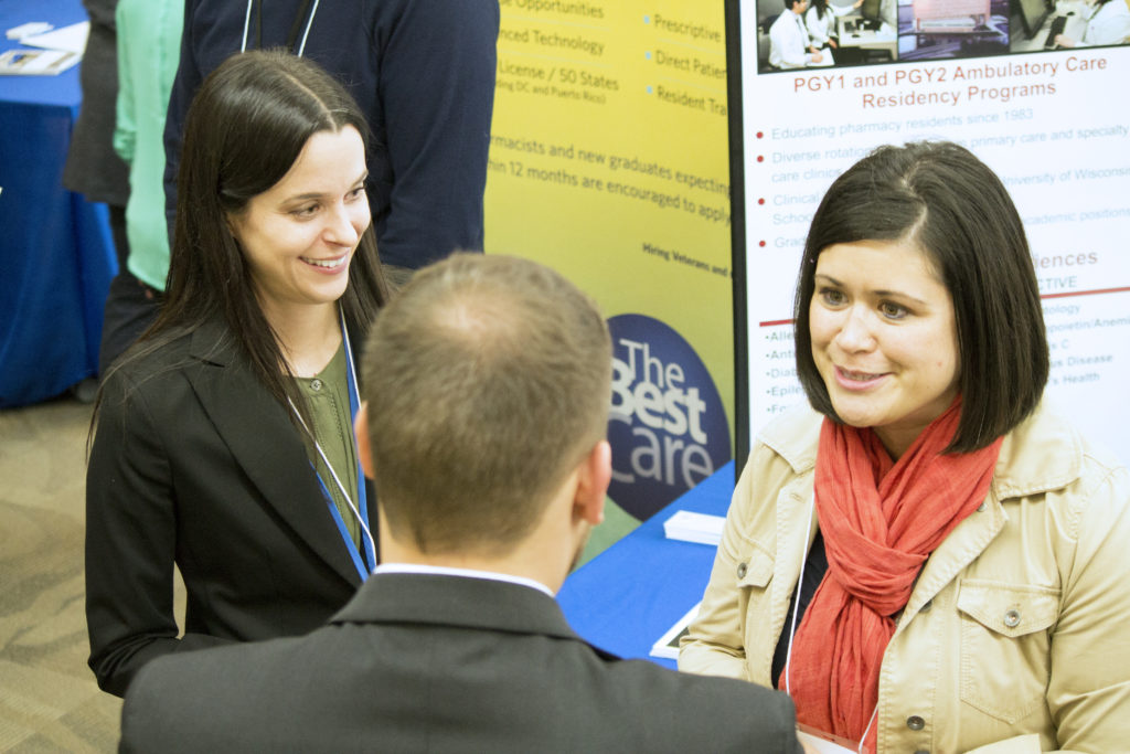 Alumna Maria Wopat speaking with a PharmD student at the School's 2018 Career Fair.