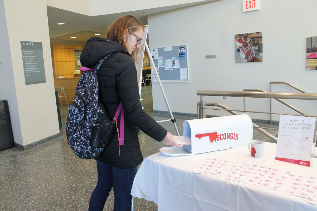 Thank a Badger Day with student putting card into mailbox