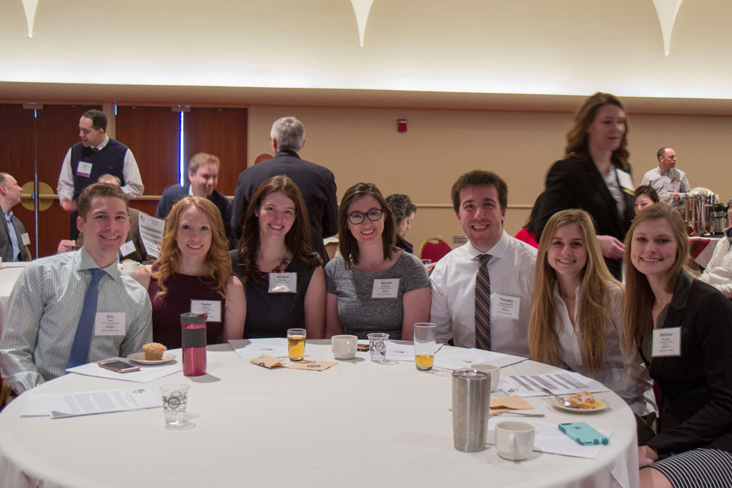 20180208-IMG_3460 Small group of students gathered around table at an event