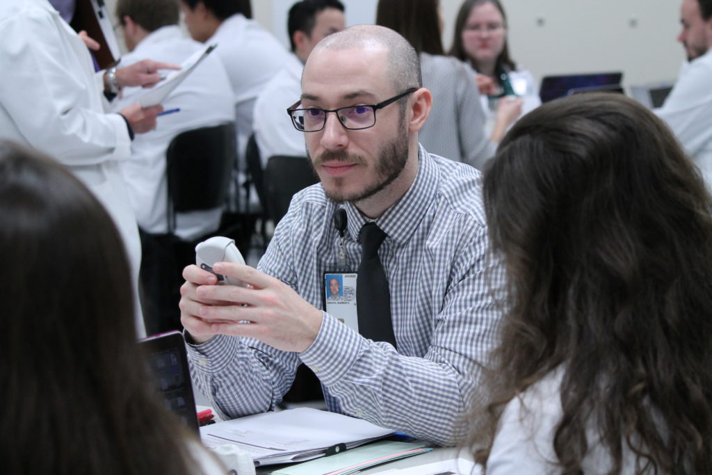 2019-PTx-Asthma-Lab-057 Student holding asthma medical device during lab
