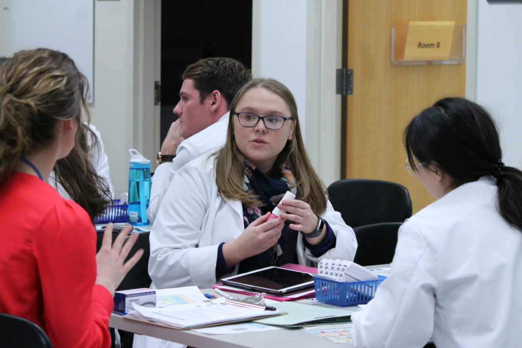 2019-PTx-Asthma-Lab-063 Instructor teaching students at table for asthma lab