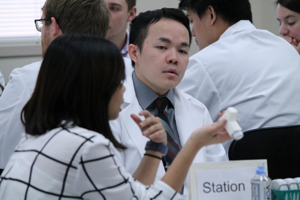 2019-PTx-Asthma-Lab-098 Students looking at asthma inhalers