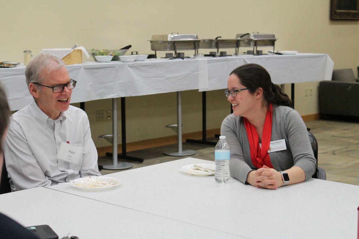 2020-Annual-Clinical-Instructors-Mtg-44 Amanda Margolis and Paul Lata smiling together at a table