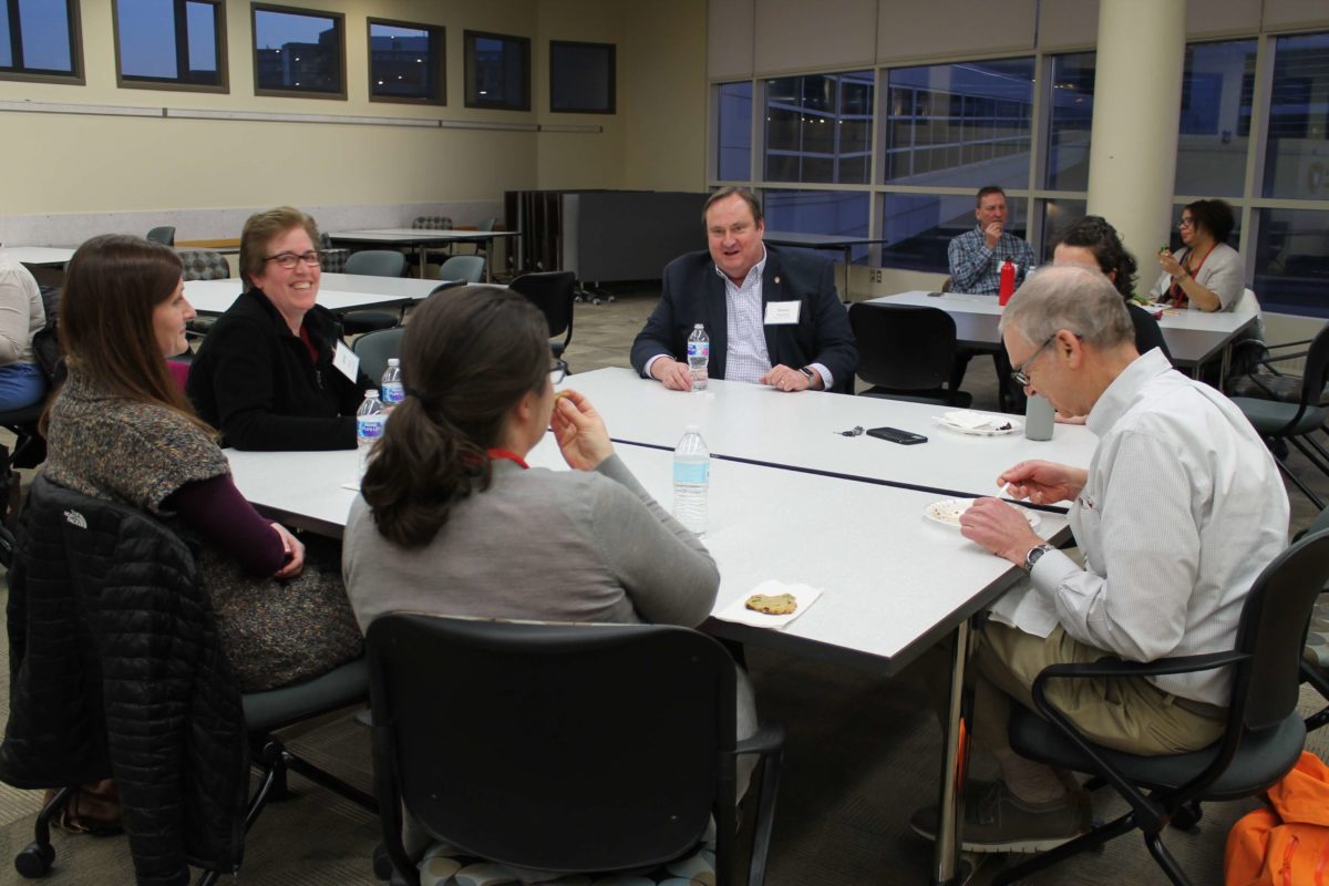 2020-Annual-Clinical-Instructors-Mtg-56 Health professionals with Dean Steve Swanson eating food from a buffet hosted for the 2020 Annual Clinical Instructors Meeting