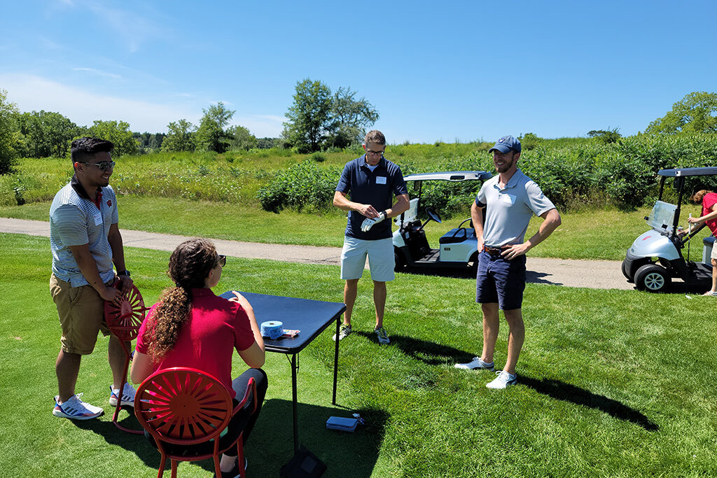 20210813_123620 Pharm alum talking to check-in at golfing event
