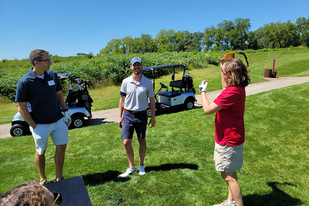 20210813_123712 Pharm alum talking together on a golf course