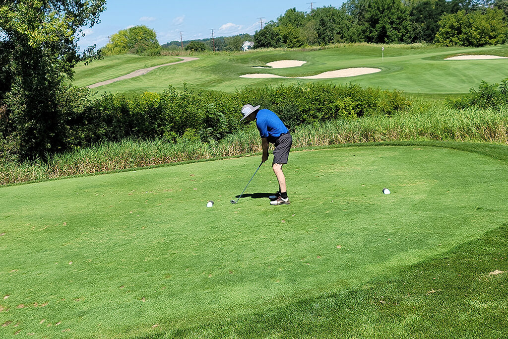 20210813_130249 Pharm Alum taking a shot on a golf course