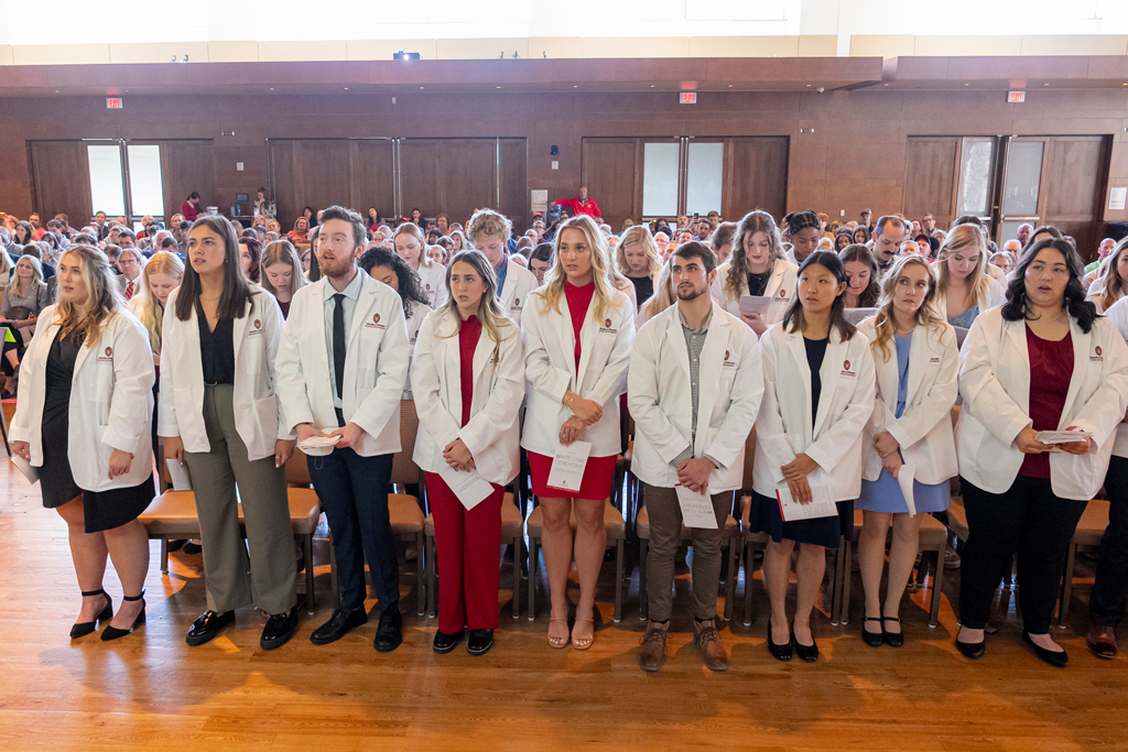 School of Pharmacy White Coat Ceremony Sunday, Sept. 17, 2003. Students in white coats standing from their seats