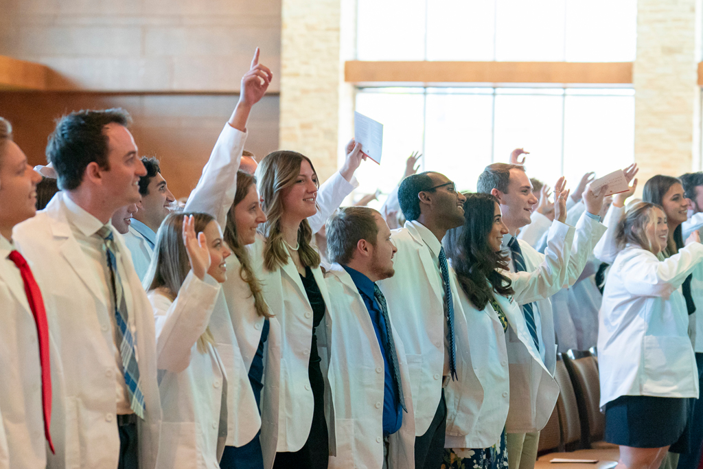 School of Pharmacy White Coat Ceremony Sunday, Sept. 17, 2003. Students in their white coats celebrating in audience