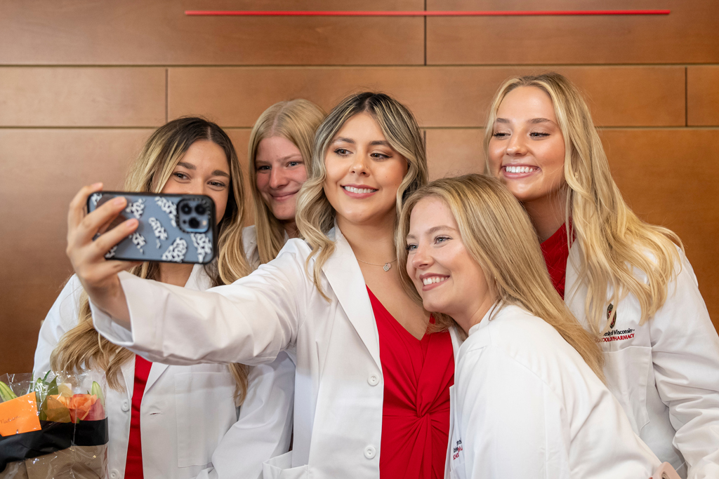 School of Pharmacy White Coat Ceremony Sunday, Sept. 17, 2003. Students in white coats grouped together for a selfie