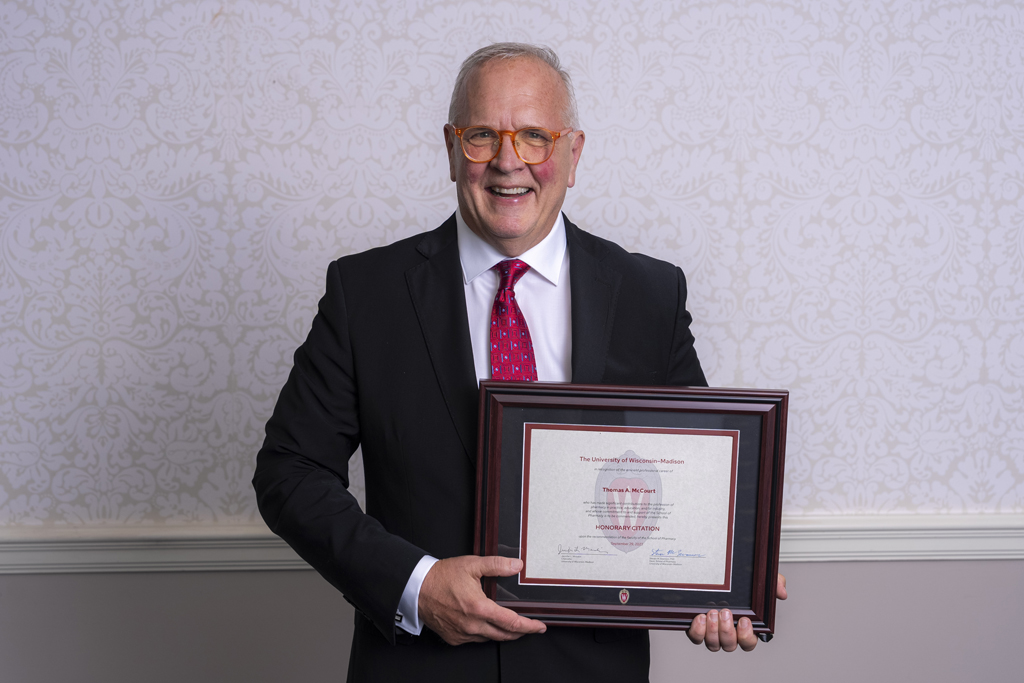 Tom McCourt poses with his 2023 Citation of Merit award.