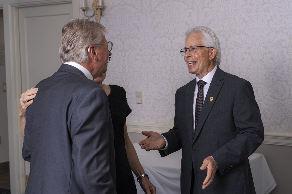 Bob Breslow greets two guests