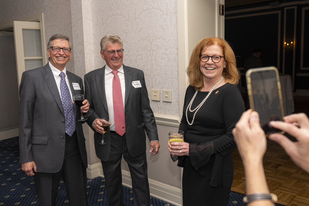 Kathy Skibinski, Ron Behling, and others smile for a photo
