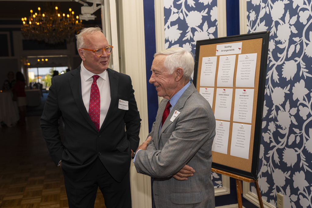 Tom McCourt and Loren Ames speak near an entrance