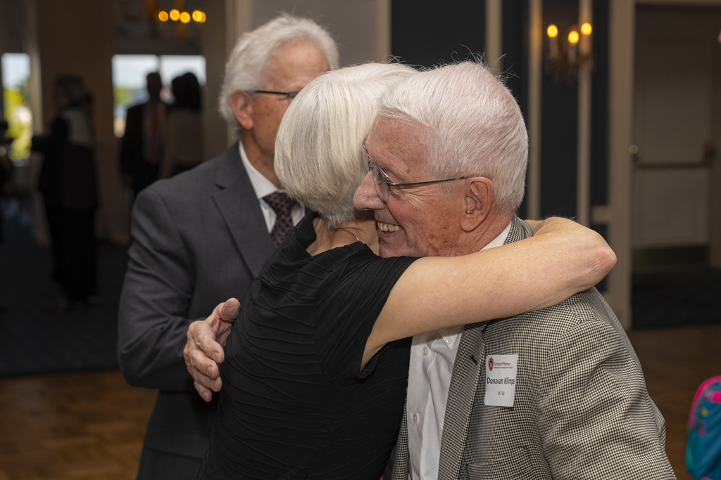 Donovan Klimpel and another attendee embrace