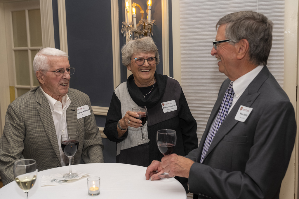 Bonnie Svarstad and two attendees laugh in conversation