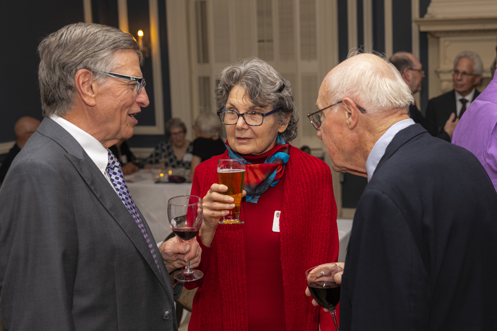 Three attendees gather and catch up at the Citations event