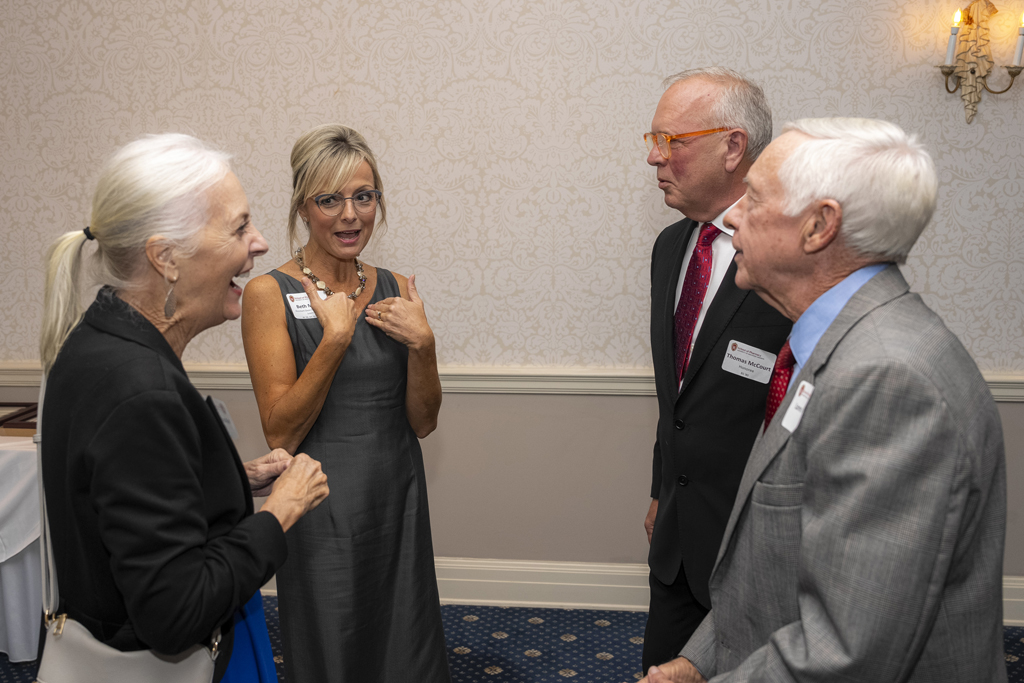 Beth Martin, Tom McCourt, and two attendees chat