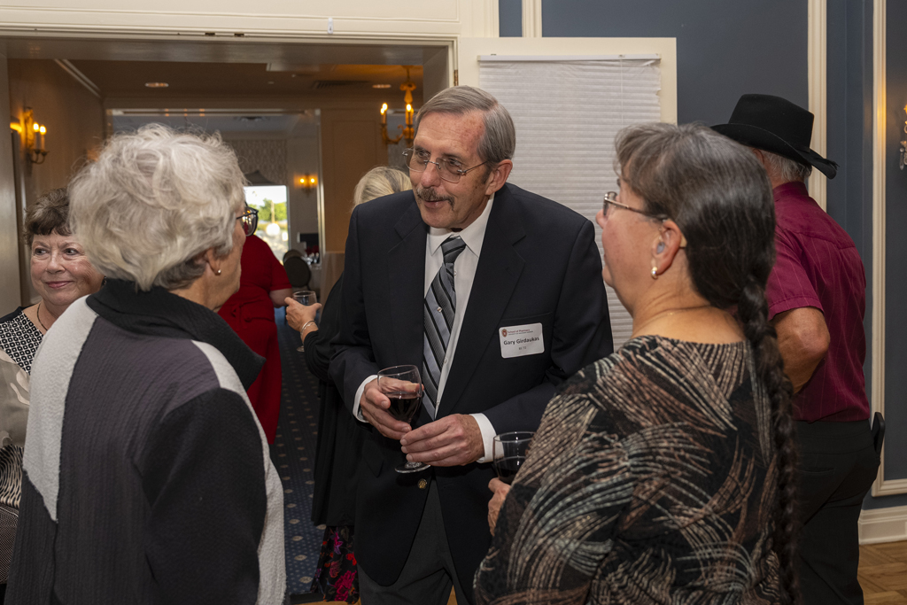 Gary Girdakis and other attendees speak