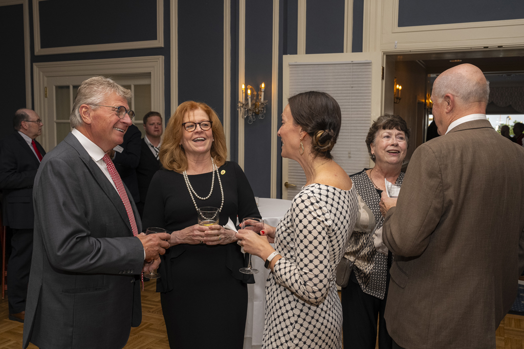 Kathy Skibinski and two other attendees smile in conversation