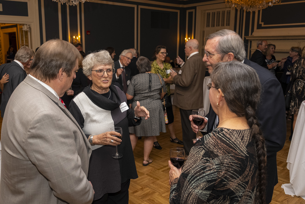 Gary Girdakis and his wife speak with Steve Swanson and another attendee