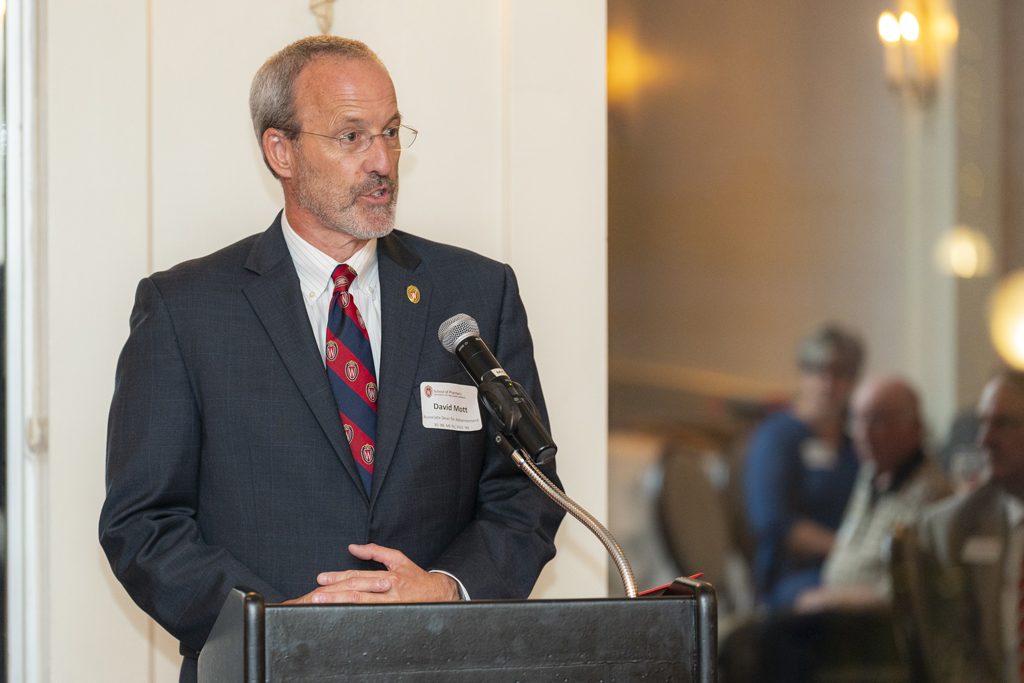 Dave Mott speaks at the podium