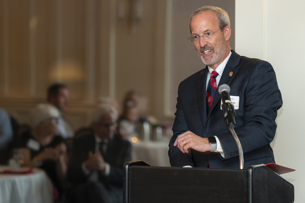 Dave Mott speaks at the podium