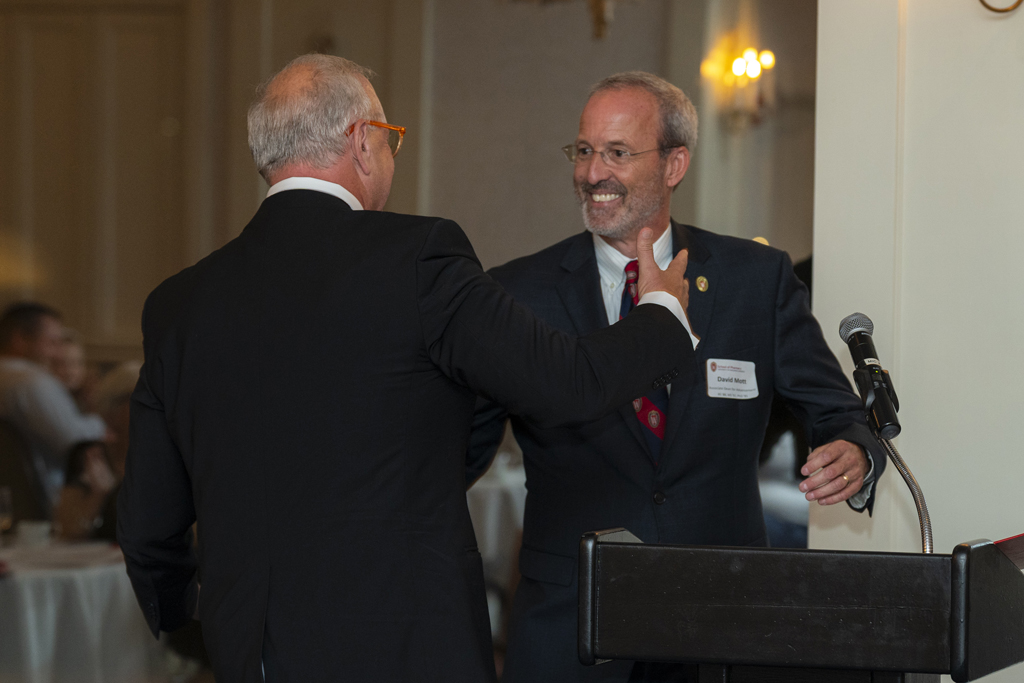 Tom McCourt greeting Dave Mott at the podium