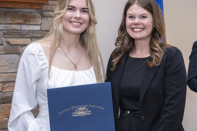PharmD Graduation Awards Breakfast at the Pyle Center May 10, 2024. A graduate receives an award from Andrea Porter