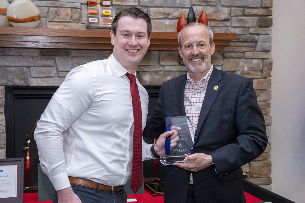 PharmD Graduation Awards Breakfast at the Pyle Center May 10, 2024. A graduate receives an award from Dave Mott