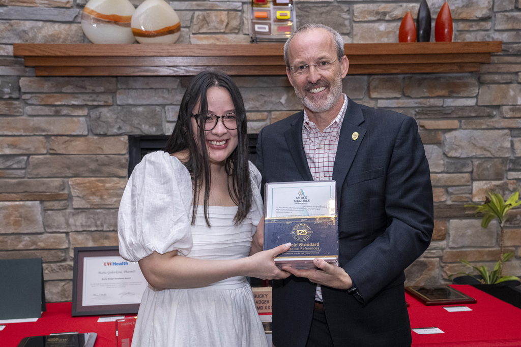 PharmD Graduation Awards Breakfast at the Pyle Center May 10, 2024. A graduate receives an award from Dave Mott