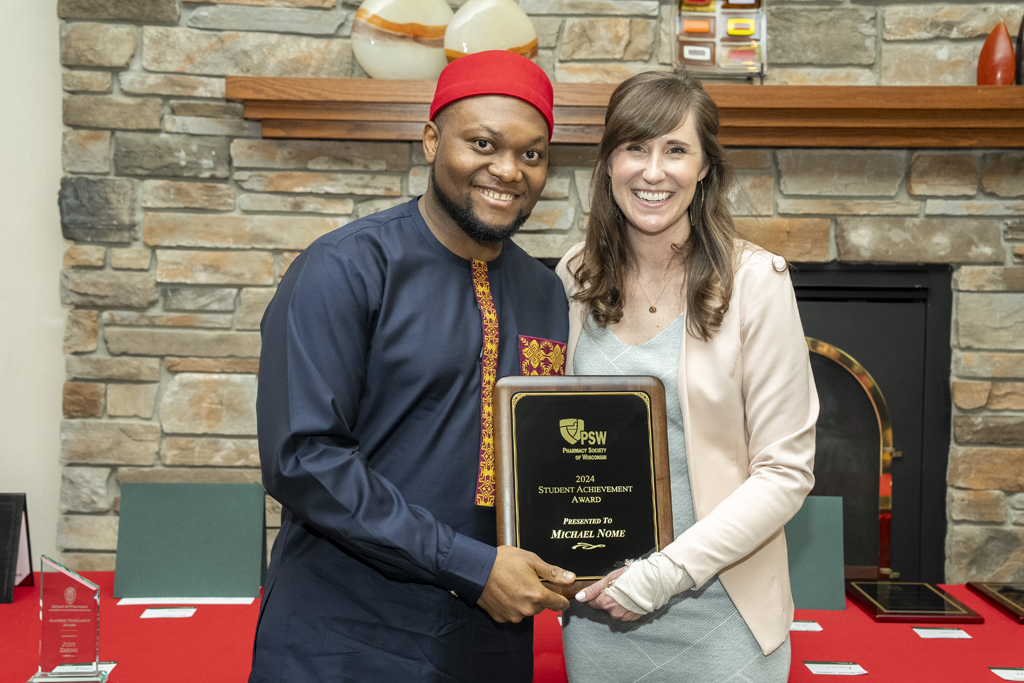 PharmD Graduation Awards Breakfast at the Pyle Center May 10, 2024. Michael Nome receives an award from Kate Hartkopf