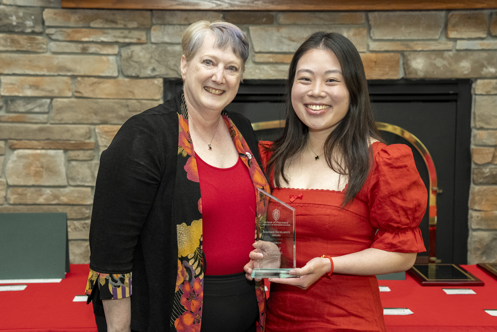 PharmD Graduation Awards Breakfast at the Pyle Center May 10, 2024. Judy Zheng receives an award from Karen Kopacek