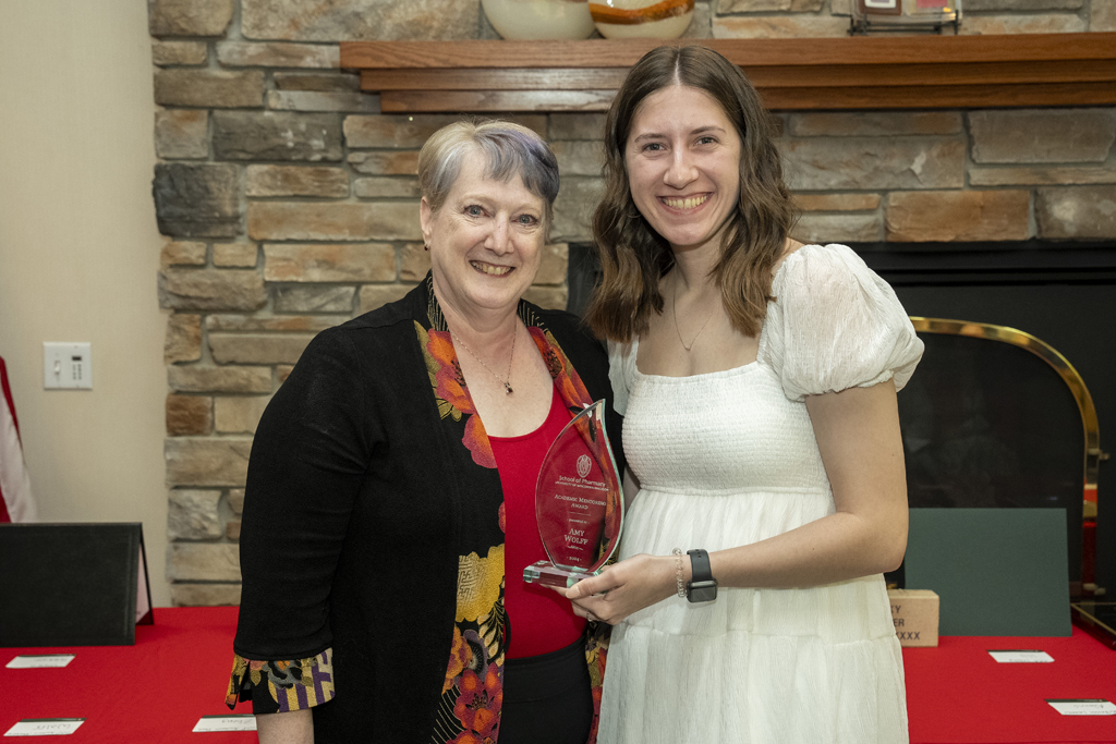 PharmD Graduation Awards Breakfast at the Pyle Center May 10, 2024. Amy Wolff receives an award from Karen Kopacek