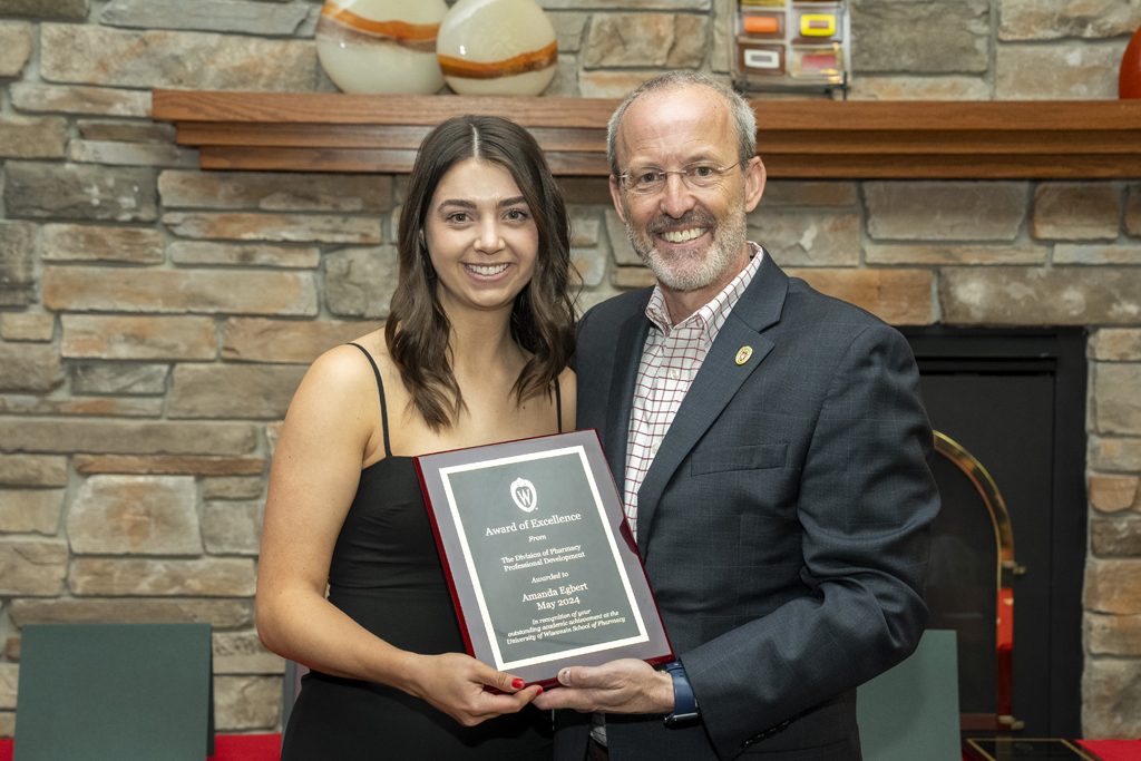 PharmD Graduation Awards Breakfast at the Pyle Center May 10, 2024. Amanda Egbert receives an award from Dave Mott