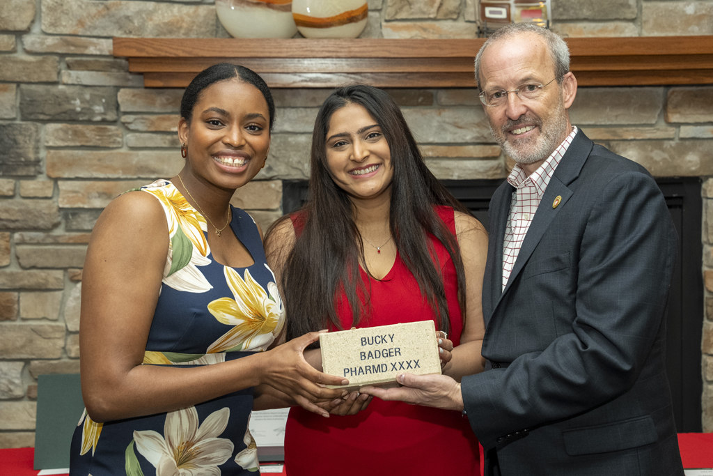 PharmD Graduation Awards Breakfast at the Pyle Center May 10, 2024. Maria Hill and another graduate receive legacy bricks from Dave Mott