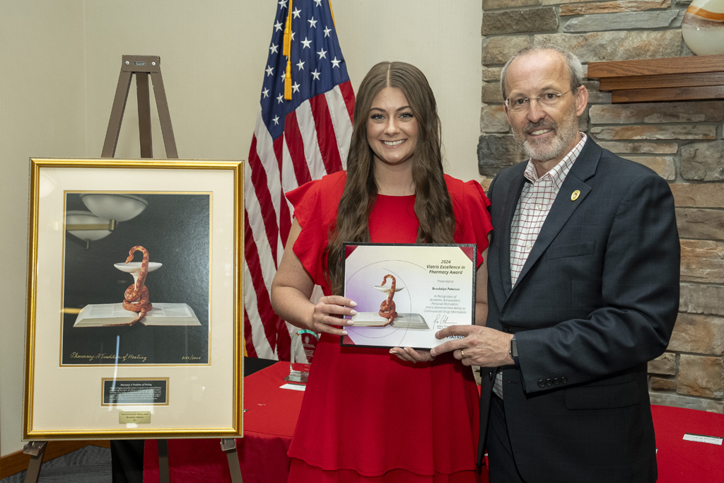 PharmD Graduation Awards Breakfast at the Pyle Center May 10, 2024. Dave Mott presents an award to Brookelyn Peterson