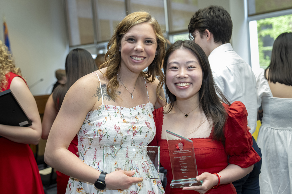 PharmD Graduation Awards Breakfast at the Pyle Center May 10, 2024. Two graduates pose with their awards