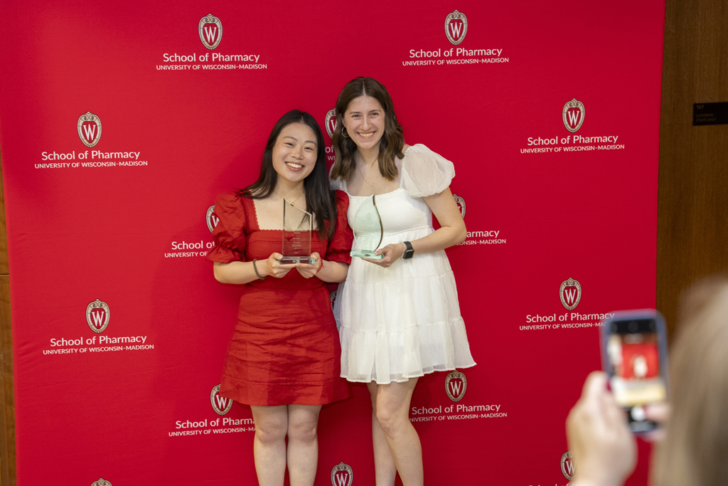PharmD Graduation Awards Breakfast at the Pyle Center May 10, 2024. Two graduates pose with awards