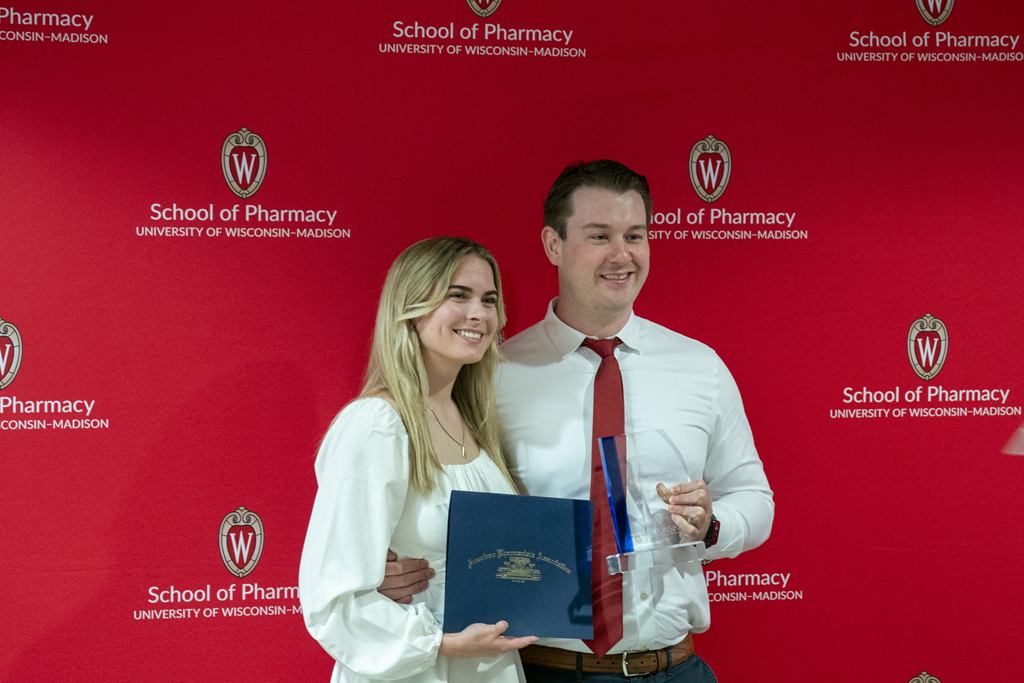 PharmD Graduation Awards Breakfast at the Pyle Center May 10, 2024. Two graduates pose with awards