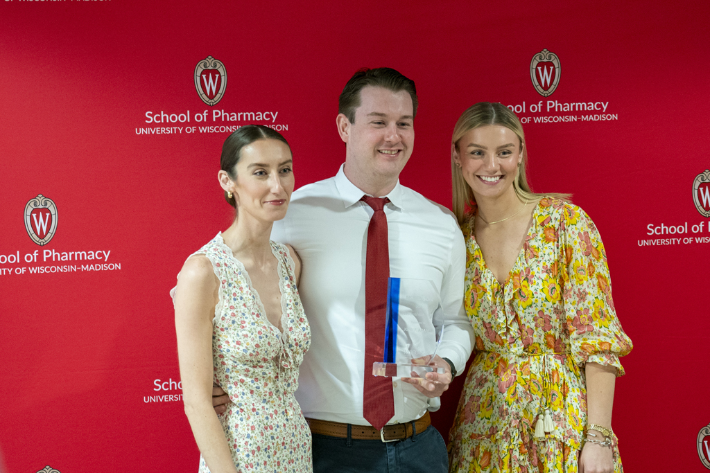 PharmD Graduation Awards Breakfast at the Pyle Center May 10, 2024. A graduate poses with an award and two guests