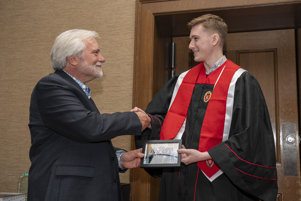 PharmTox Brunch at Carson Gulley May 11, 2024. (Photo © Andy Manis) A student accepts a class photo from Jeff Johnson